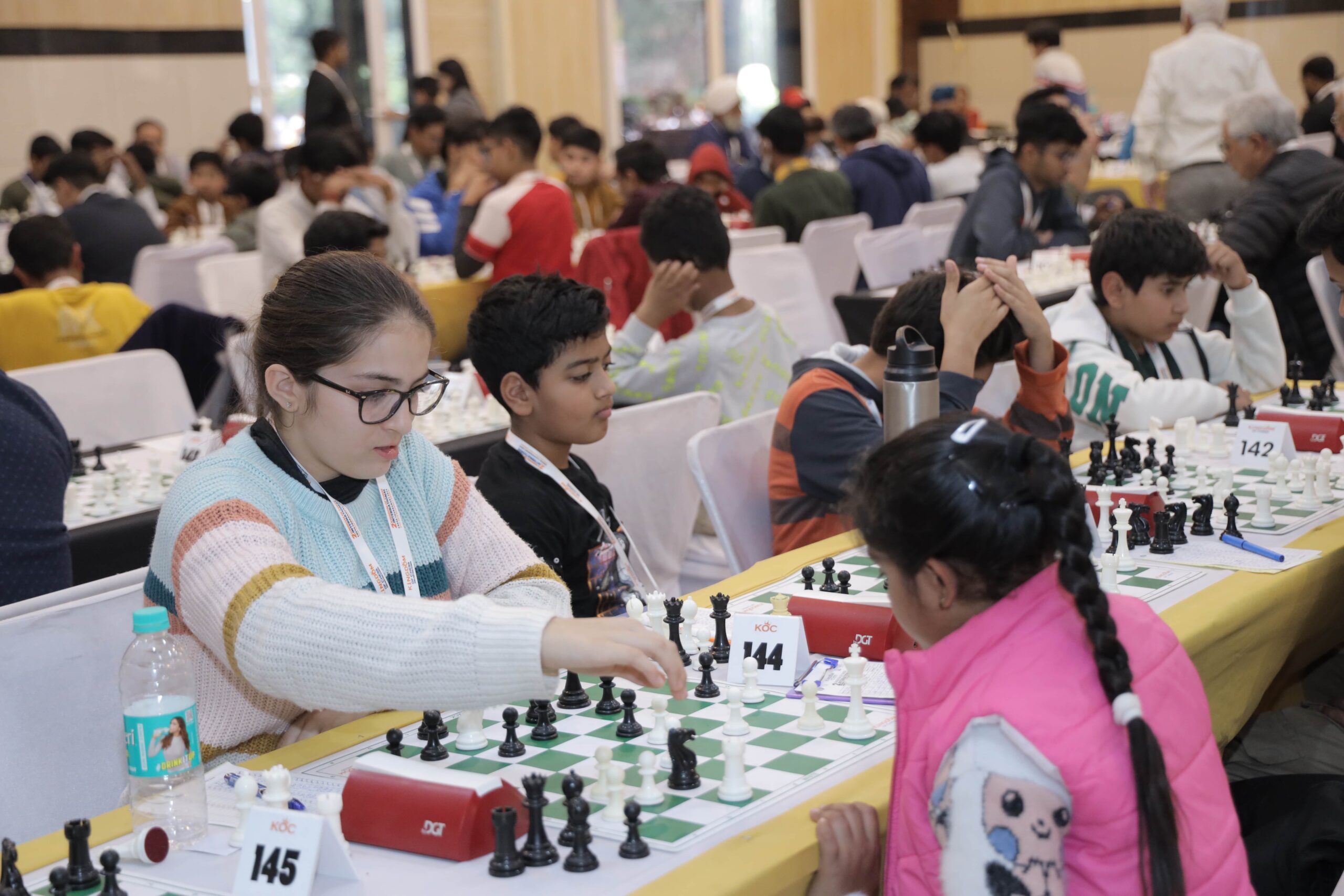 Kids playing chess by kingdom of chess